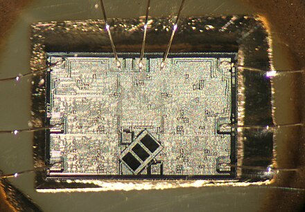 The optical chip extracted from a CD player. The three dark rectangles are photosensitive, read the data from the disk and keep the beam focused. Electronic tracking, aided with the two photodiodes at the sides, keeps the laser beam centered on the middle of the data track.