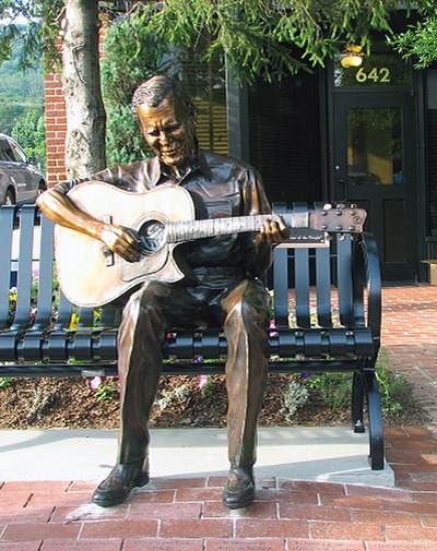 Sculpture of Doc Watson at the corner King and Depot Streets in Boone, North Carolina; he would invite Old Crow to perform at MerleFest after hearing 