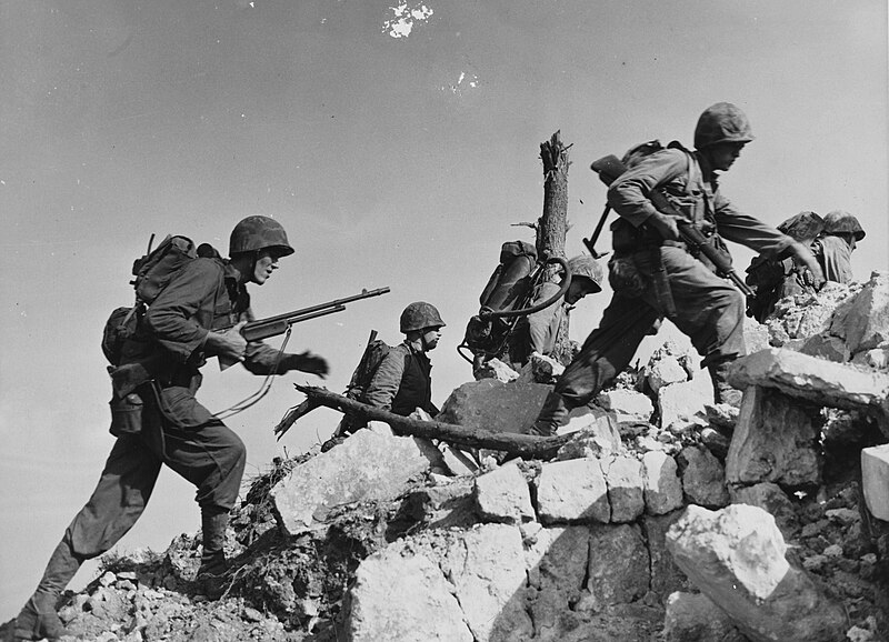 File:Equipped for any emergency, Marines hurdle a stone wall as they push across Okinawa. (49487691958).jpg