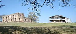 The ruins of the west barracks (left) and the reconstructed south barracks (right) in 2009. In 2010, the south barracks would be destroyed by fire. Fort Washita Both Barracks.jpg