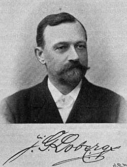 Svartvitt fotografi på Johan Gustaf Loberg. Han har stora mustascher och litet skägg. Under bilden syns en namnteckning.