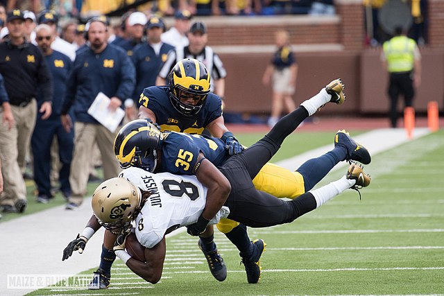 File:Josh Uche makes a tackle (29670349561).jpg - Wikimedia Commons