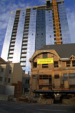 The house in 2008, after being moved back to its original site, with Ladd Tower in the background Ladd Carriage House on moving day 2008-10-25.jpg