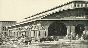 General Sherman's mandatory evacuation order led to this photograph of the last train leaving Atlanta. With overloaded cars, it will not have enough room for civilians to bring all of their belongings which can be seen littered beside the tracks beside the wagons they left behind and the two chests.