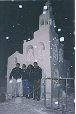 Mexican sculptor Abel Ramírez Águilar posing with other members of team Graciela Ferreiro, Gabriel Rayar and Robert Hancock in front of their snow sculpture Little Village at the International Snow Sculpture Championships in 1999