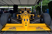 Фото передней части желтого одноместного автомобиля на стенде