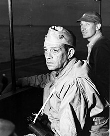 Rear Admiral Sprague photographed on the bridge of Fanshaw Bay, as the Okinawa landings proceeded, circa April 1945.