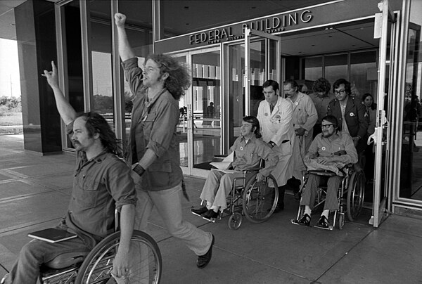 Kovic (left) leading other disabled veterans after ending their 17-day hunger strike, March 1974