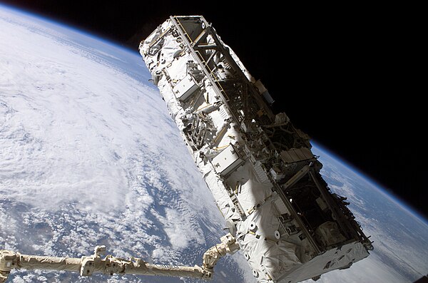 Canadarm2 grapples the first segment of the ISS' Integrated Truss Structure