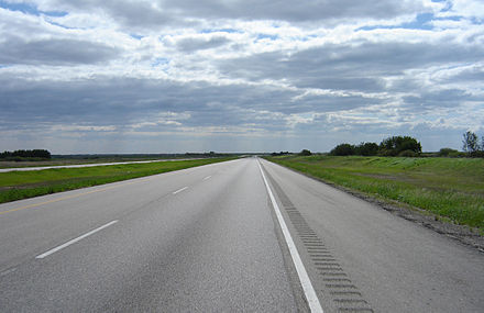 The shoulder of Saskatchewan Highway 11 in this picture (shown to the right of the solid white line) is wide enough to accommodate a stopped car without impeding the flow of traffic in the travel lanes