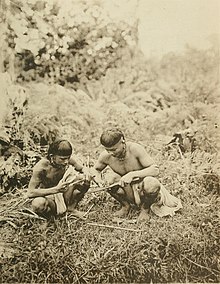Two native Borneans designated as "Klemantans" by Charles Hose. Original caption in his 1912 book: Klemantans making fire in the jungle by sawing one piece of bamboo across another. The pagan tribes of Borneo; a description of their physical, moral and intellectual condition, with some discussion of their ethnic relations (1912) (14598224757).jpg