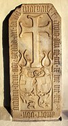 Gravestone of Andreas von Graben zu Sommeregg with the coats of arms of Von Graben (left) and Barbara (and Jörg) von Hallegg (right) on the outer wall of the church in Treffling