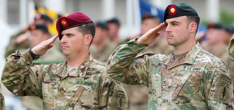 Two officers from 7th Special Forces Group (Airborne), one wearing a maroon beret and the other a rifle-green beret, participate in change of command ceremony, 2017 US Army 7th Special Forces Group change of command ceremony.png