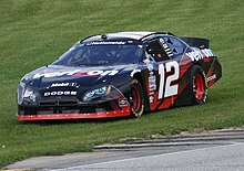 Allgaier slides his car through the grass at Road America in 2010 12JustinAllgaier2010Bucyrus200RoadAmerica.jpg