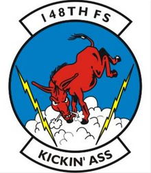 148th Fighter Squadron emblem, a visual pun in which the squadron's motto, "Kickin' Ass", is depicted literally as an ass in the act of kicking even though "kicking ass" is a colloquial expression for winning decisively or being impressive. 148FS USAF emblem.png