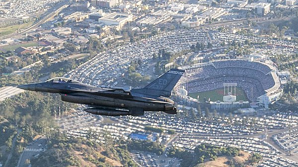 An F-16 Fighting Falcon flies past Dodger Stadium during the pre-game ceremonial flyover before Game 2.