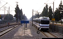 A Blue Line (now A Line) train heads south out of Willowbrook/Rosa Parks station along former right of way of the Long Beach Line, October 1995 19951007 07 RTD LRT Compton, CA (5379432836).jpg