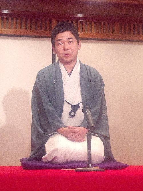 A rakugoka (storyteller) wearing kimono and 5-mon haori