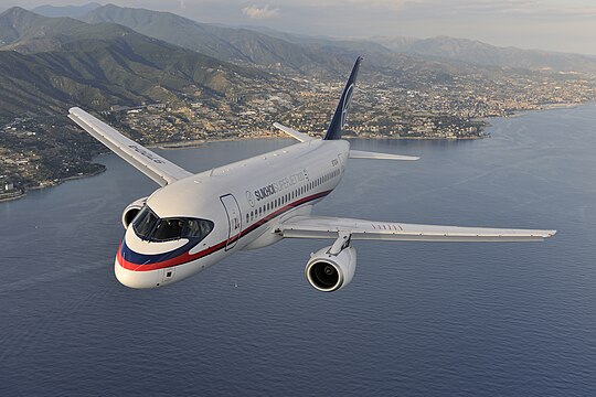 "Air-to-air_photo_of_a_Sukhoi_Superjet_100_(RA-97004)_over_Italy.jpg" by User:File Upload Bot (Magnus Manske)