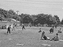 Cherry pickers playing baseball at an orchard work camp in Door County, Wisconsin, July 1940 Baseball game cherry pickers camp.jpg