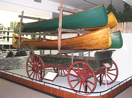 In the Adirondacks at portages that were heavily used, horse-drawn wagons like this one were furnished with racks for carrying several boats at once, for a fee. This example is typical of those used in the 1890s. (Adirondack Museum).
