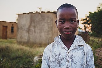 A boy in Blouberg amongst some dwellings Boy in Blouberg, Limpopo.jpg