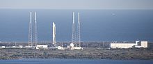 SLC-40 with SpaceX Falcon 9 launch infrastructure, February 2015. The four towers surrounding the rocket are lightning rods. Falcon 9 preparing to launch DSCOVR (16491702277) crop.jpg