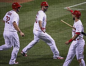 Adam Wainwright (middle) flanked by teammates Matt Adams (left) and Matt Carpenter (right) after hitting a three-run home run on May 2, 2016 Gladhand.jpg