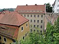 Residential house in open development, but leaning against the castle bridge