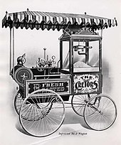 An early popcorn machine in a street cart, invented in the 1880s by Charles Cretors in Chicago. Improved no2 Wagon.jpg