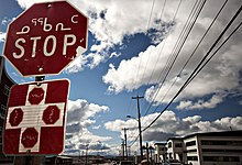 A stop sign in Iqaluit. The sign features the two most-spoken languages in the city, English and Inuktitut.