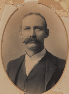 Black and white photograph of man with moustache