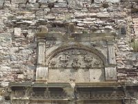 tympanum with the Jazłowiecki Abdank coat of arms on fortress wall