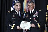 Gen. Mark A. Milley, Army chief of staff, presents Lt. Gen. Robert L. Caslen with a certificate authorizing his presentation of the Army Distinguished Service Medal at Caslen's relinquishment of command ceremony on 22 June 2018. Lt. Gen. Robert L. Caslen Relinquishment of Command and Retirement Ceremony (2).jpg