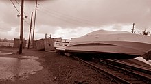 Boats, containers and other items washed onto the Long Beach Branch by Hurricane Sandy just south of Island Park station. Metropolitan Transportation Authority (New York)- 2012-10-309509-22-3895991 (8140464961).jpg