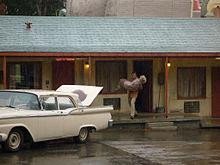 An actor playing Norman Bates carries a corpse from the Bates Motel on the Studio Tour. Norman Bates with Corpse.jpg