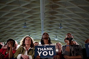 A member of the audience holds a "Thank Y...