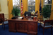 Presidential cat Socks sitting at the Resolute desk in 1994 Photograph of Socks the Cat Sitting Behind the President's Desk in the Oval Office- 01-07-1994 (6461515323).jpg