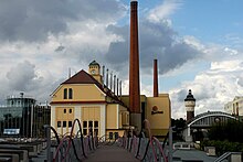 Traditional fermenting building (centre) and modern fermenting building (left) Pilsner Urquell Brewery.jpg