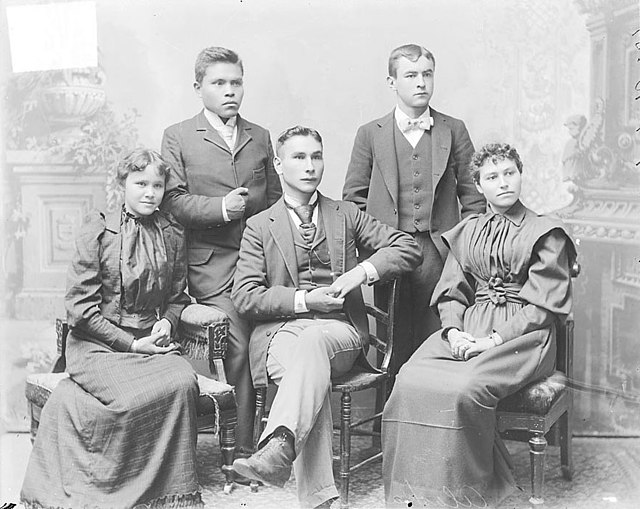 Portrait of Marsdin, non-native man, and group of students from the Alaska region