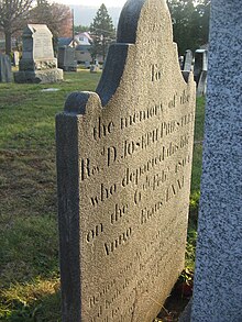 Priestley's original 1804 gravestone in Riverview Cemetery, Northumberland, Pennsylvania. Visible at right is part of the new stone, placed in front of it in 1971. Priestley Graves VIII.jpg