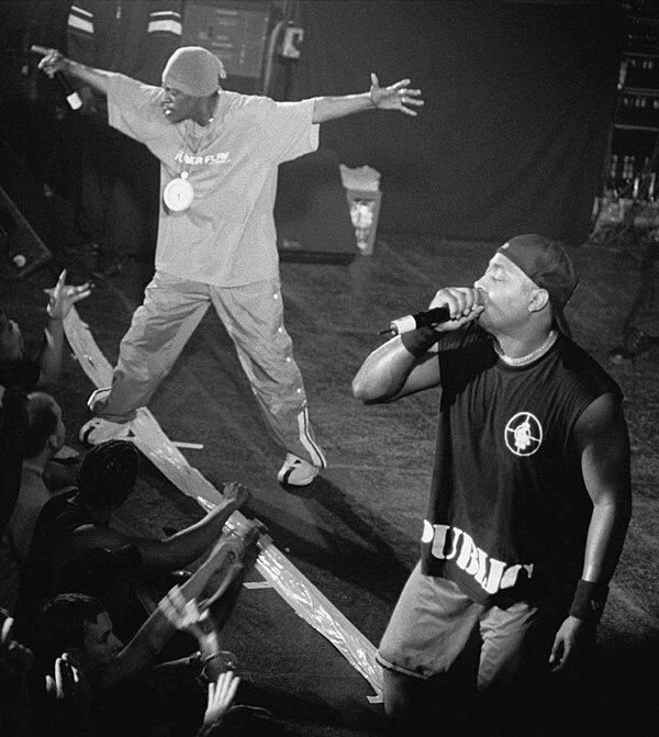 Hype man Flavor Flav (left) exciting the crowd while lead rapper Chuck D performs.