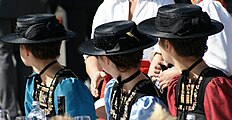 Women wearing Bregenz Forest costumes and "Schäohüte" (summer straw hats)