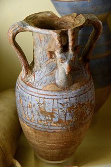 Storage jar, brown fabric. Blue decorations with lotus flower. Ibex or gazelle's head peeking out from vegetation. 18th Dynasty. From Koptos (Qift), Egypt. The Petrie Museum of Egyptian Archaeology, London