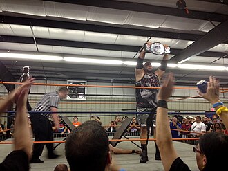 Team 3D (The Dudley Boyz) posing with the 2CW Tag Team titles after defeating Kevin Steen and Jason Axe in Watertown, New York in 2014 Team 3D - 2CW.jpg