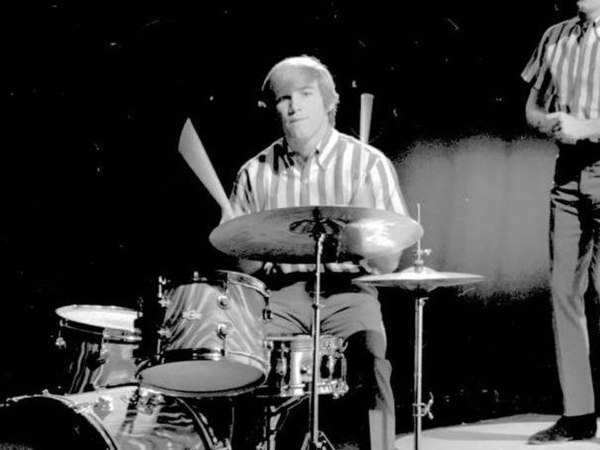 Dennis Wilson performing with the Beach Boys in 1964. According to Parks, the title "Surf's Up" was inspired by Dennis' complaints regarding British a