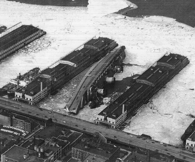 The Normandie, renamed USS Lafayette, lies capsized in the frozen mud at Pier 88 in the winter of 1942