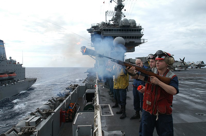 File:US Navy 031103-N-5821P-003 Aviation Ordnanceman Airman Ralph Jones, from Detroit, Mich., fires a shot line to USNS Yukon (T AO 202).jpg