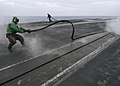US Navy 040714-N-9742R-013 Flight deck personnel assigned to USS Enterprise (CVN 65) Air Department's V-2 Division remove the slot seals from the waist catapults on the ship's flight deck prior to morning flight operations.jpg