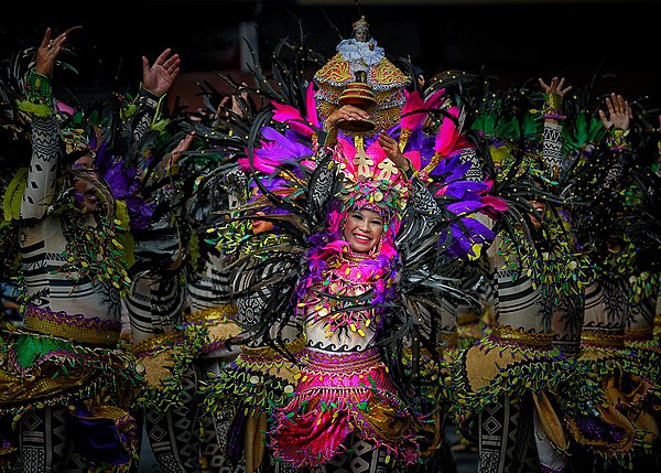 Carrying the Holy Child Jesus, locally known as Santo Niño, this Festival Queen praises the Holy Child with her contingent.